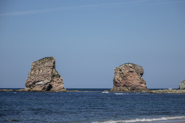 Fototapeta premium 3 km long, the longest beach in the Basque Country is in Hendaye. Two-twins (Les Deux-Jumeaux) at Cape Sainte-Anne on the background. Hendaye, Basque Country coast, Pyrenees Atlantiques, France,