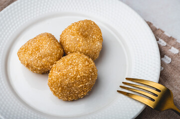 Pinoy Snack or Merienda – Buchi is a type of Chinese fried pastry made from glutinous rice flour, a sweet filling, and sesame seed coating (Close up profile)