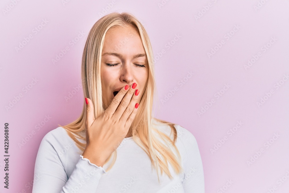 Canvas Prints young blonde girl wearing casual clothes bored yawning tired covering mouth with hand. restless and 