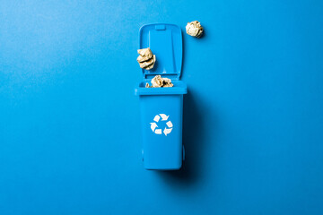 Recycling icon. Bin container for disposal garbage waste and save environment. Blue dustbin for recycle paper trash isolated on blue background.