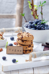 Breakfast with cookies and fresn berries  on a white wooden tray.