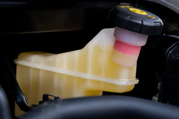 Car service. Close-up of a reservoir for brake fluid in a car engine. Brake fluid tank. 