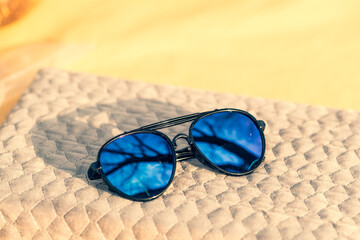 Aviator Sunglasses special model with big blue lenses reflecting the sun in a summer day shoot outdoors closeup . Selective focus. High quality photo