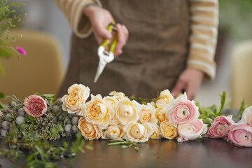 Front view close up of beautiful flowers arranged on table in florists workshop, copy space