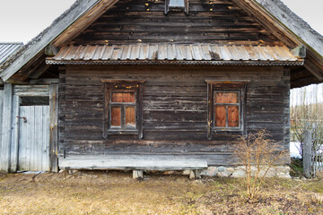 Fototapeta na wymiar old wooden peasant hut with a bench, front view