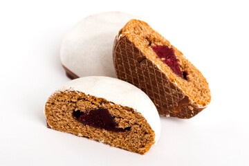 Gingerbread in a cut with a berry jam on a white background. Sweet dissert to tea. Close-up