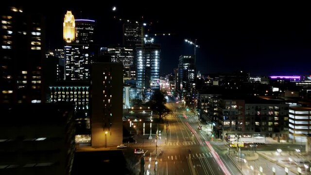 Aerial time lapse at night of Minneapolis downtown, cars passing by long exposure cityscapes