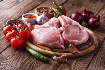 fresh raw new-york steak on wooden Board on wooden background with salt and pepper in a rustic style.