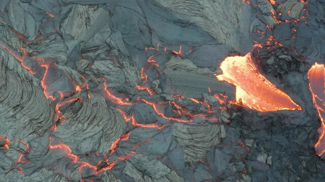 Burning flowing volcanic lava, birdseye aerial view, eruption of dormant volcano after 6000 years, Fagradalsfjall, Iceland