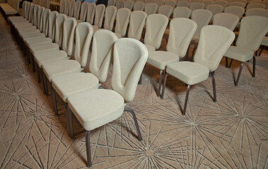 White chairs in the conference room. empty seat in conference meeting hall . White Chairs in the Conference Room just before a business meeting takes place.