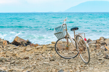 old bicycle on a rocky seashore