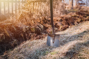 Gardener digging in a garden with a spade. Big shovel close up.