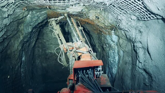Walls of the underground mine are getting drilled by a bore. Underground development, underground extraction, underground mining operations.