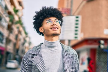 Fototapeta premium Young african american businessman smiling happy standing at the city.