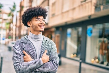 Young african american businessman smiling happy standing at the city.