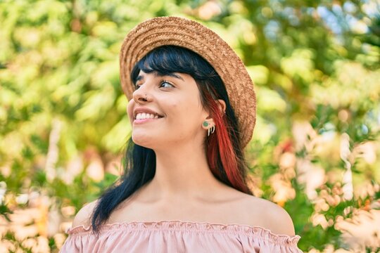 Young hispanic tourist girl wearing summer style walking at the park.