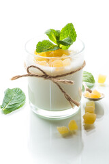 Sweet homemade yogurt with candied fruits in a glass
