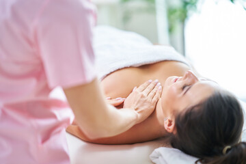 Fototapeta na wymiar Adult woman during relaxing massage in spa