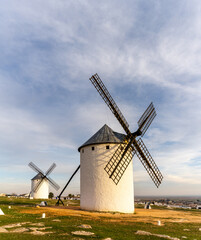 Fototapeta na wymiar the historic white windmills of La Mancha above the town of Campo de Criptana in warm evening light