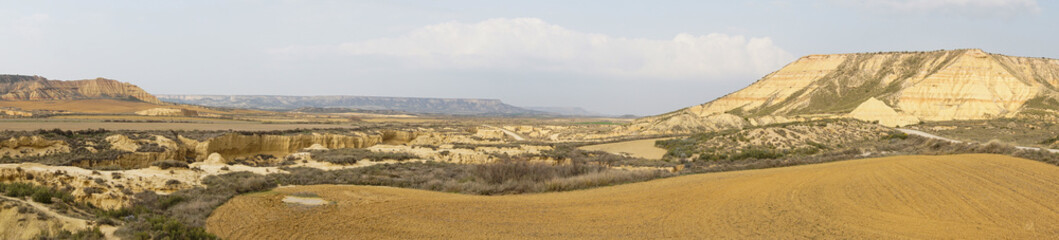 panorama view of the desert grasslands and mesas and table mountains in the Bardenas Reales desert in northern Spain