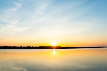 Naklejka na ściany i meble Sunset in the lake, beautiful sunset above the sea landscape background