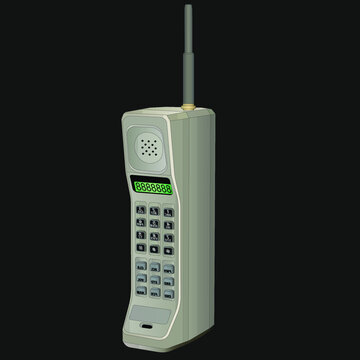 A big, old, gray cell phone with an antenna, gray buttons, and green numbers. One of the first wireless phones