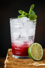 Cocktail with Malina, Mint and Ice on old books
