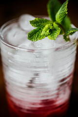 Cocktail with Malina, Mint and Ice on old books