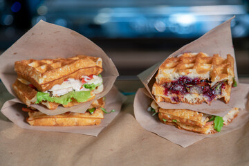 Sandwich in a paper bag close-up. Sandwich filet americain, close up of burger. Fast, but unhealthy food