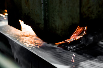 Surface grinding of metal with an abrasive stone on a surface grinder.