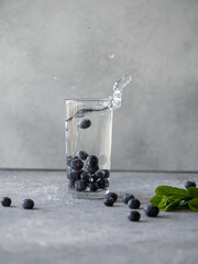 Glass with water and blueberry, splashes and bubbles