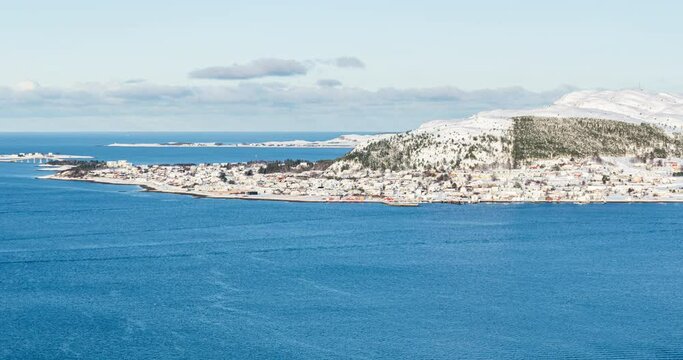 Breathtaking time lapse of winter wonderland Valder&oslash;y island that is being filmed from &Aring;lesund. Fjords, hills, mountains, islands are present. In the foreground ships and boats are passing by.