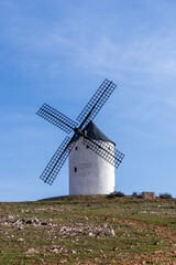 Fototapeta na wymiar whitewashed historic windmill typical of the La Mancha region of central Spain under a blue sky
