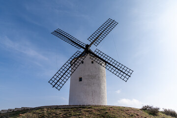 Fototapeta na wymiar whitewashed historic windmill typical of the La Mancha region of central Spain under a blue sky