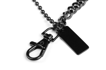 Black metal chain with carbine and tag, on a white background. Close-up. Detail for design