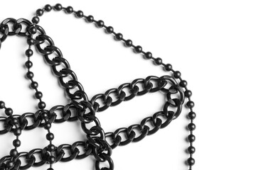 Two black, metal chains on a white background. Close-up. Detail for design. Copy space for text