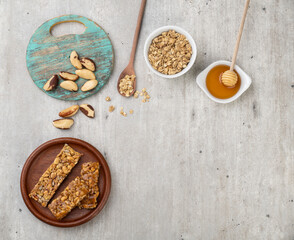Homemade cereal bars with nuts, muesli, honey and copy space