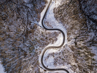 Winter aerial top view of the road to ski resort Krasnaya Polyana. Beautiful winter landscape from drone.