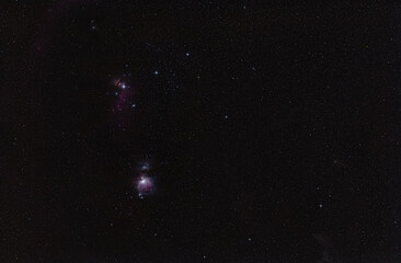 Winter night sky with purple Orion nebula many spiked stars visible