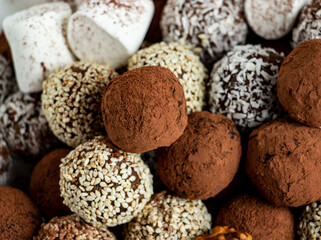 truffles with cocoa, coconut and sesame seeds with chocolate and marshmallows, delicious dessert