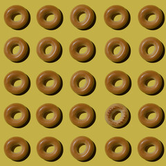 A lot of bagels pattern on a yellow color background. Bakery product template, traditional Russian bread product.