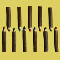 wooden color pencils on a yellow background with hard shadows, colorful bright pattern.