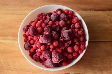 white bowl with a frozen red berries