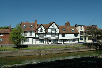 Fototapeta na wymiar Row of half-timbered houses along the water with a blue sky