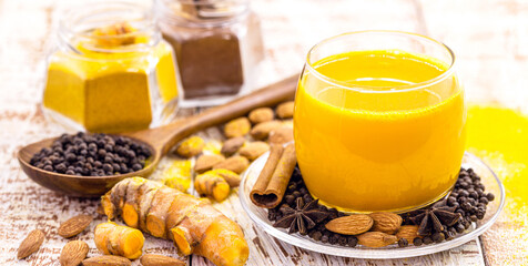Golden milk, made with turmeric and other spices, healthy saffron drink, cinnamon, star anise, black pepper and almonds
