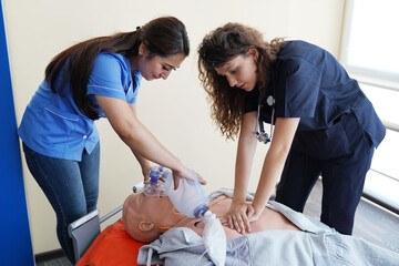 Nursing students are learning how to rescue the patients in emergency. CPR training with CPR doll.