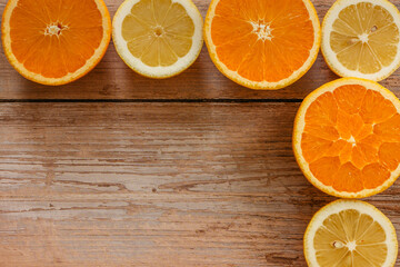 Oranges,limes and lemons slides on wooden table view from above.Beautiful background with fresh...