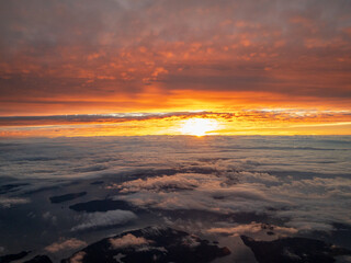 Fototapeta na wymiar A Morning Sunrise At Altitude from an Airline
