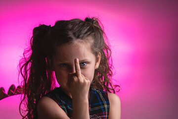 portrait of a little girl showing the middle finger