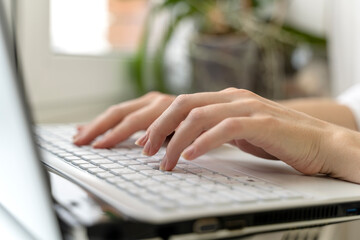 women's hands on a laptop in the